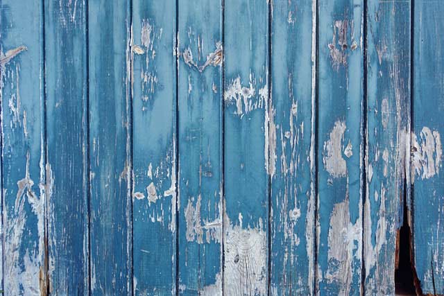 Blue wooden planks with gaps as we discuss dangers of not having acclimated wood and importance of checking moisture content