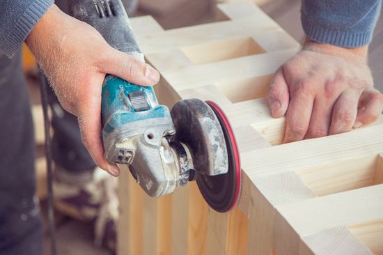 A woodworker polishing a wood project