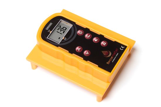 A yellow wood moisture meter for measuring the moisture content of the floor and subfloor