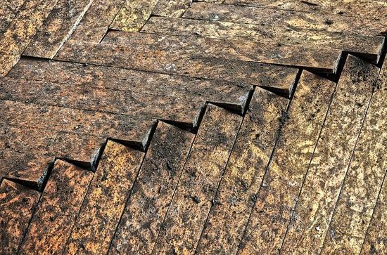 A wood floor with gaps between the boards