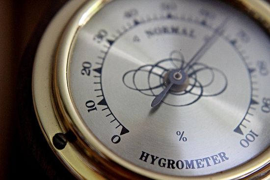 A hygrometer that measures the humidity of the air to ensure a stable climate for wood acclimation