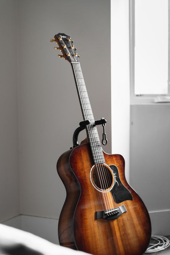 A guitar sitting in an upright holder