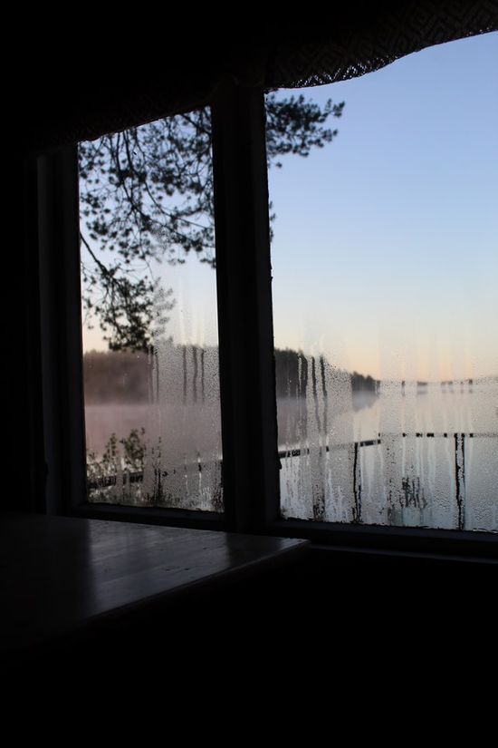 A fogged up window indicating indoor humidity which could damage wood furniture