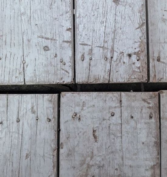 A wood floor with gaps