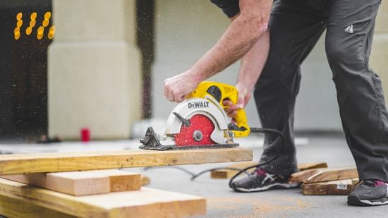 A DIY woodworker using a circular saw to cut wood