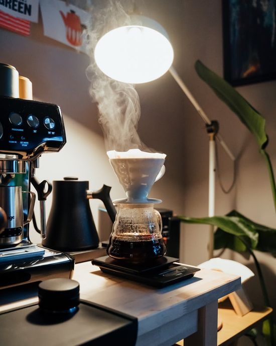 Steam rising from a coffee pot, which could cause moisture damage to cabinets over time