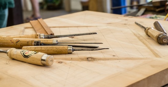 Woodworking chisels and carving knives on a work table