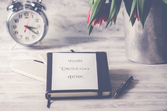  A design book for woodworking projects with a clock behind it