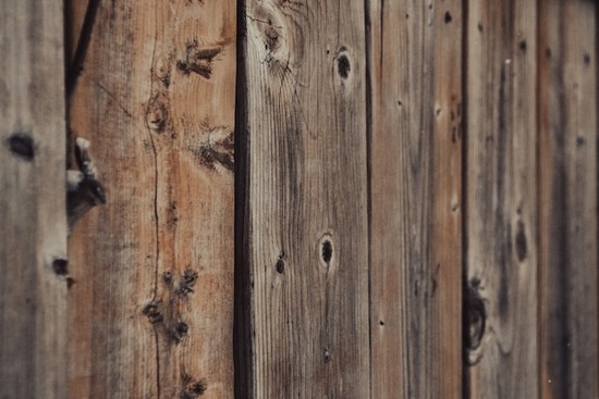 A wood fence with knots