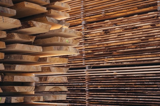 Large stacks of lumber at a lumberyard
