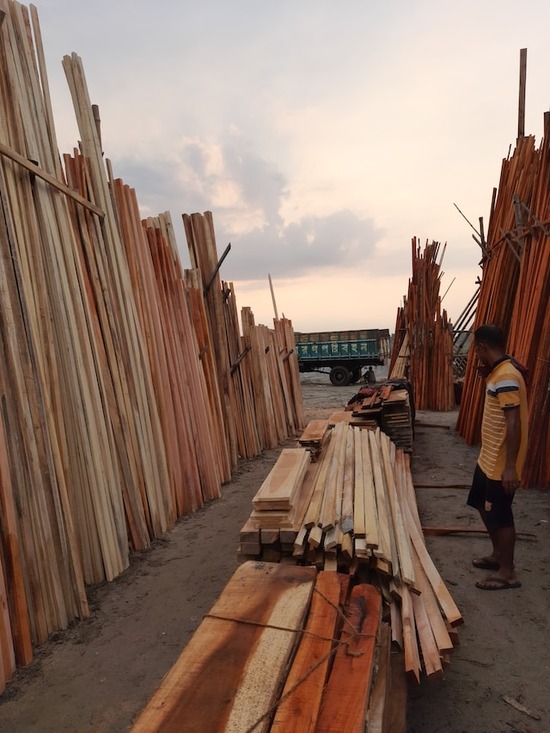 A man picking out wood at a lumberyard