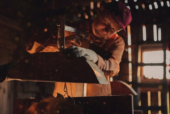 A man cutting wood with a saw