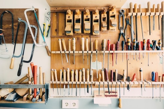 Wall racks with woodworking tools organized by type