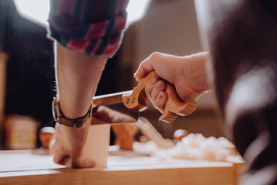 A woodworker sawing a sample of wood for oven-dry testing