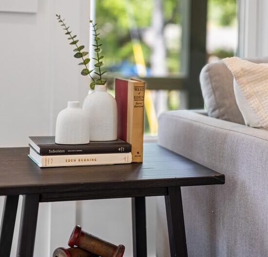 An end table with books and a vase