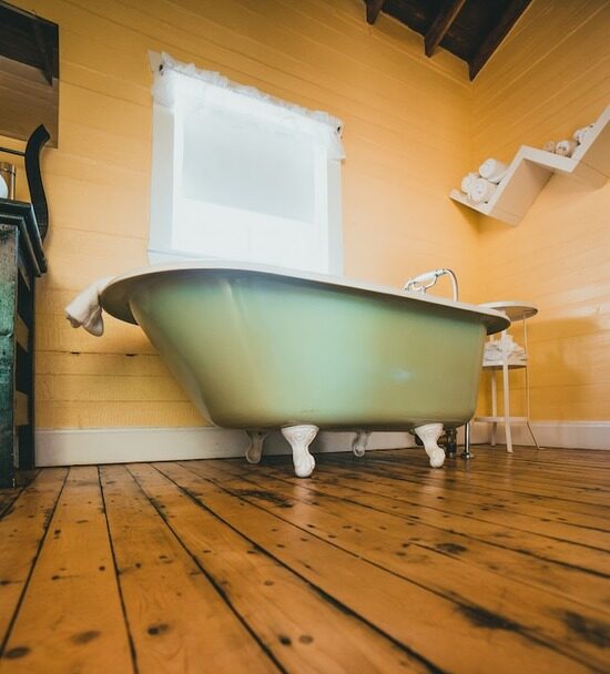  A hardwood floor underneath a bathtub