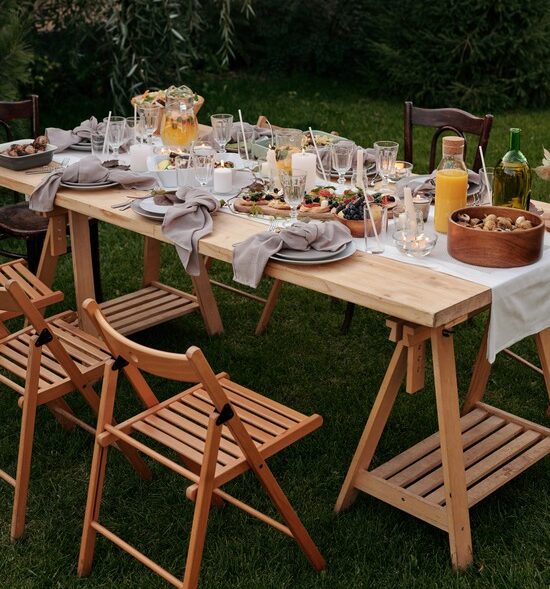 Wood patio chairs surrounding a festively set table
