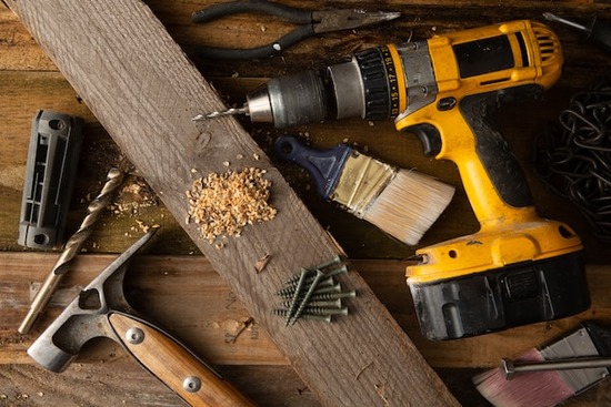 A screwdriver with wood and screws for making furniture