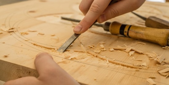 A woodworker using a chisel