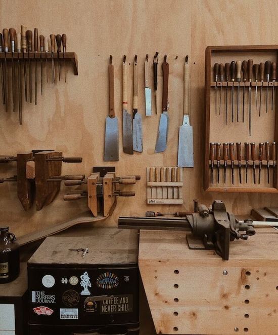 A woodworker shop with organized shelves and hooks for tools