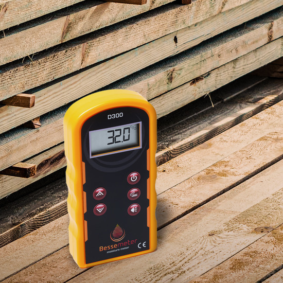 A Bessemeter D300 moisture meter on top of boards of wood