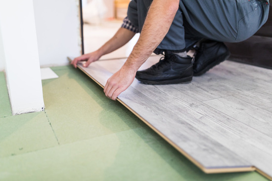 A DIYer putting in a floating floor