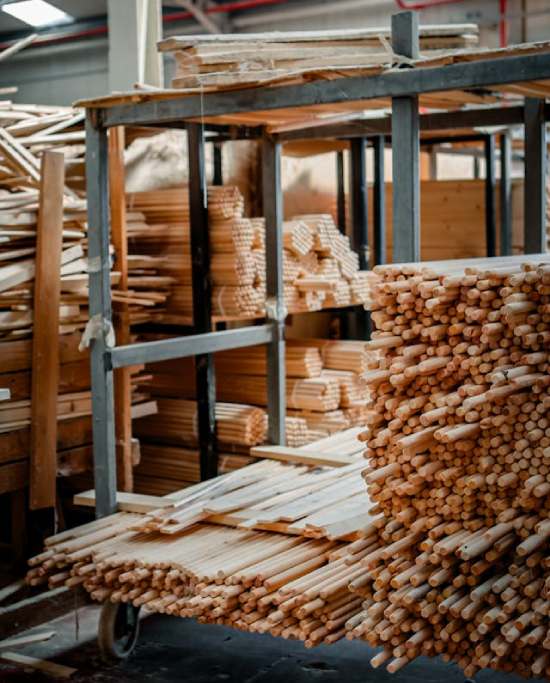A warehouse cart stacked with hundreds of wood pieces