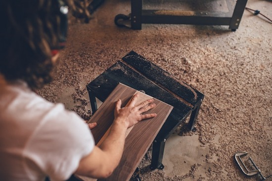 A woodworker surrounded by sawdust