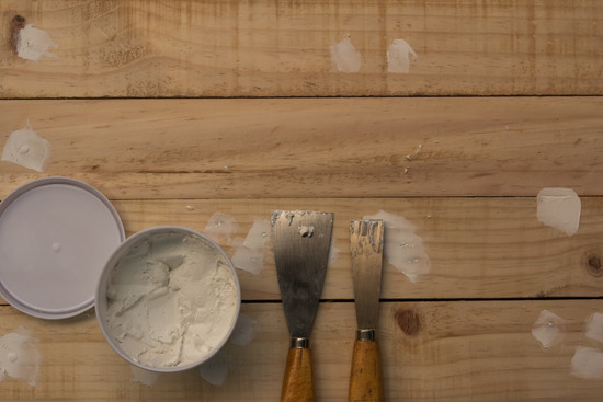 wood putty covering nail holes in the flooring