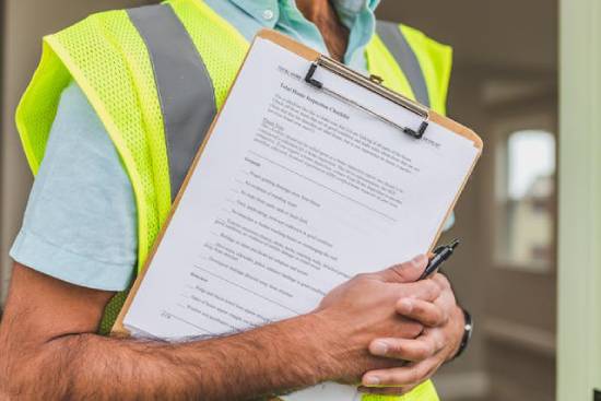 A home inspector holding a clipboard.