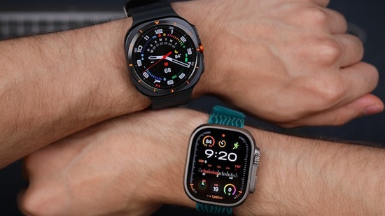 Two arms, each with a different type of fitness watch strapped around the wrist