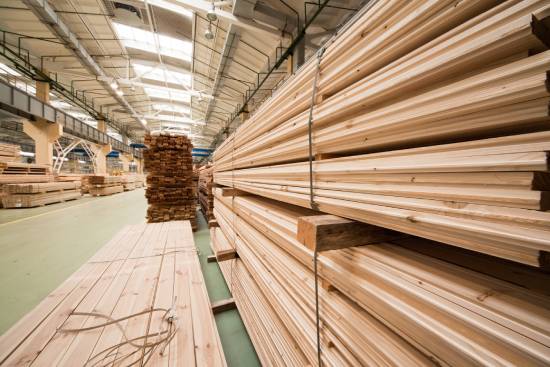 A warehouse full of stacks of wooden slabs.